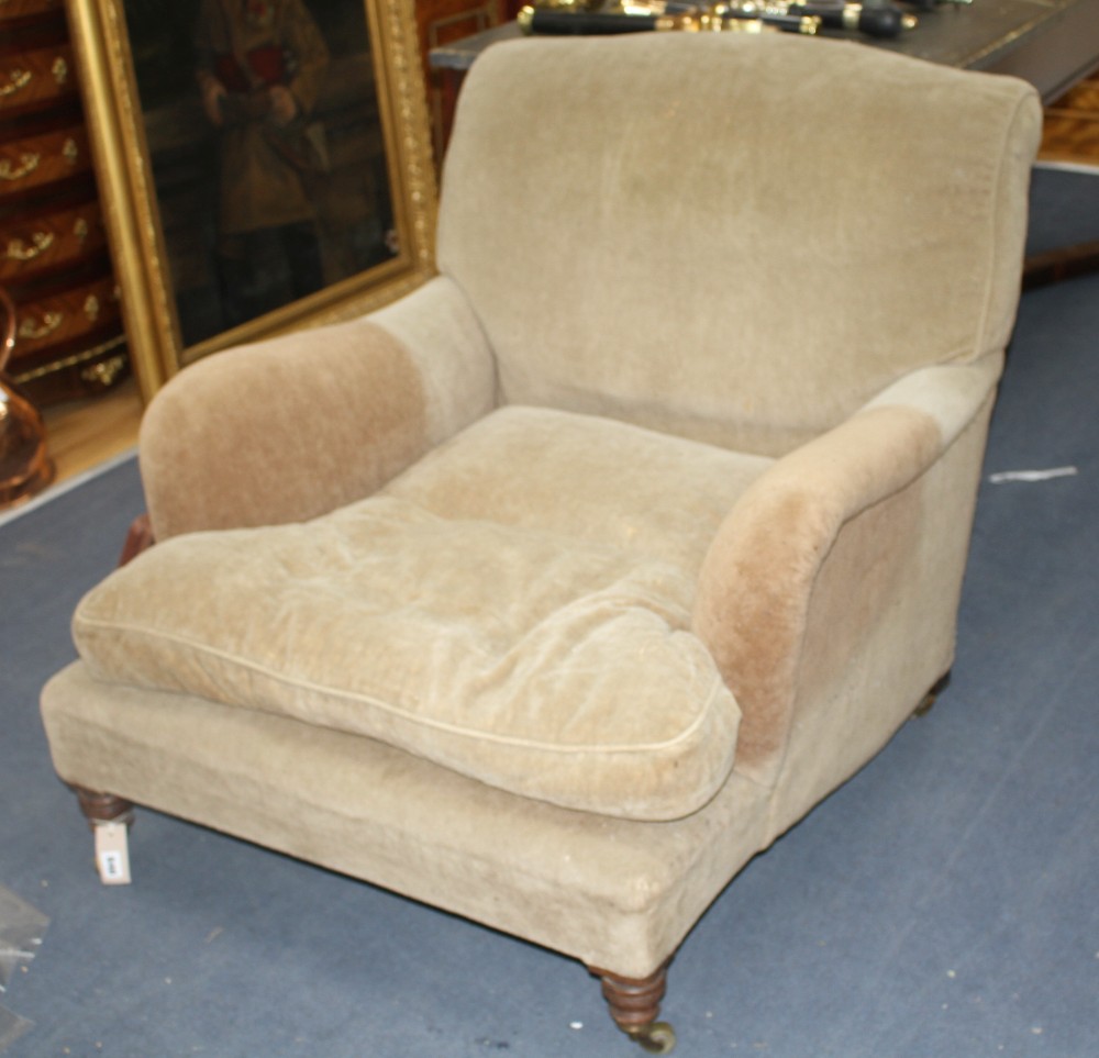 A Victorian walnut easy chair by Howard & Sons Ltd
